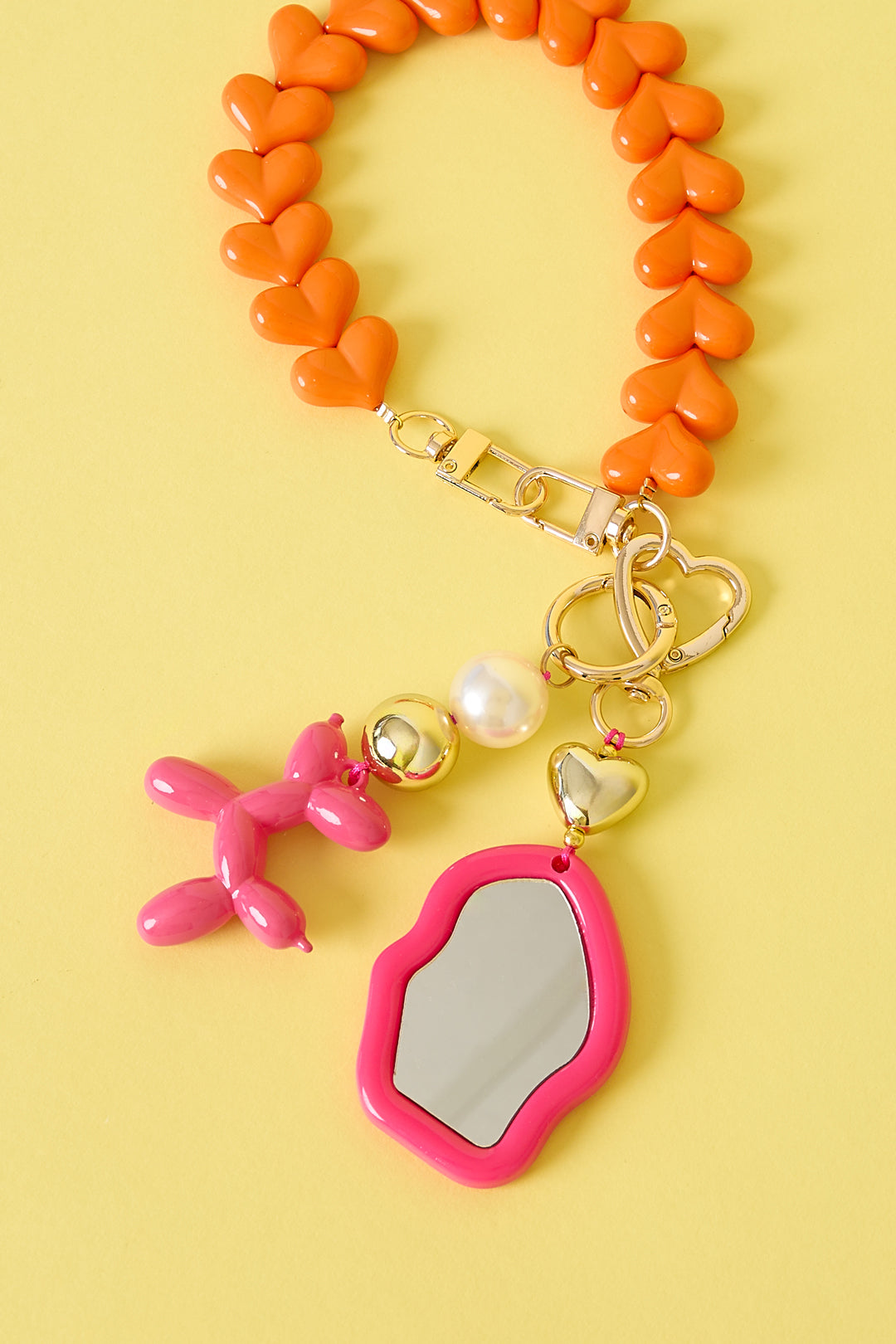 Schattige onregelmatige spiegel-tasbedel met hartdetail - donker roze - samen met andere tasbedels